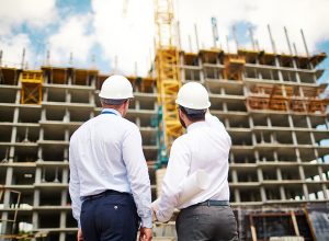 Male architects interacting by new construction